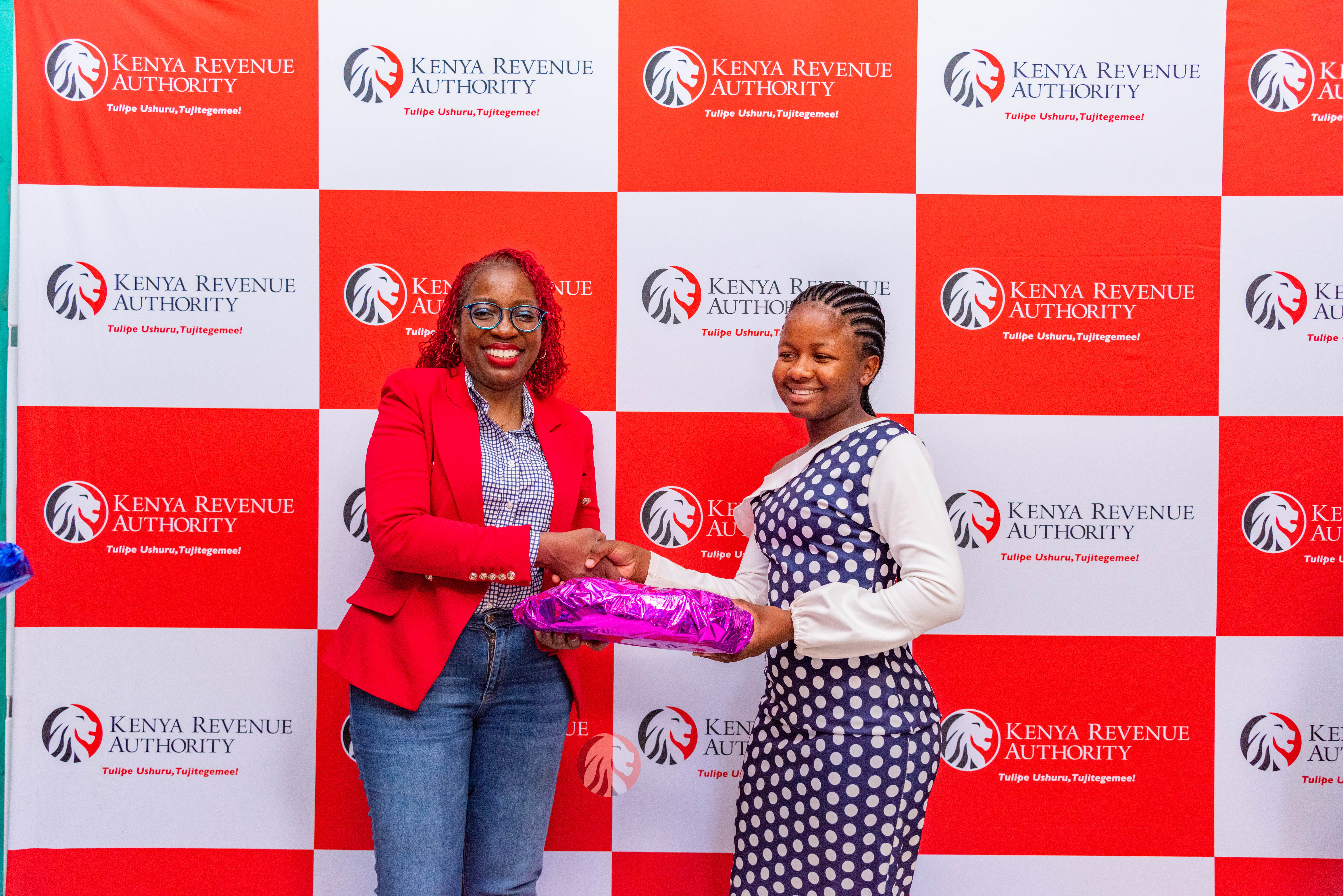 KRA inaugural Mentorship Session Ms. Sheila Mugusia of KRA awarding one of the beneficiaries of the Janris Foundation at the mentorship session